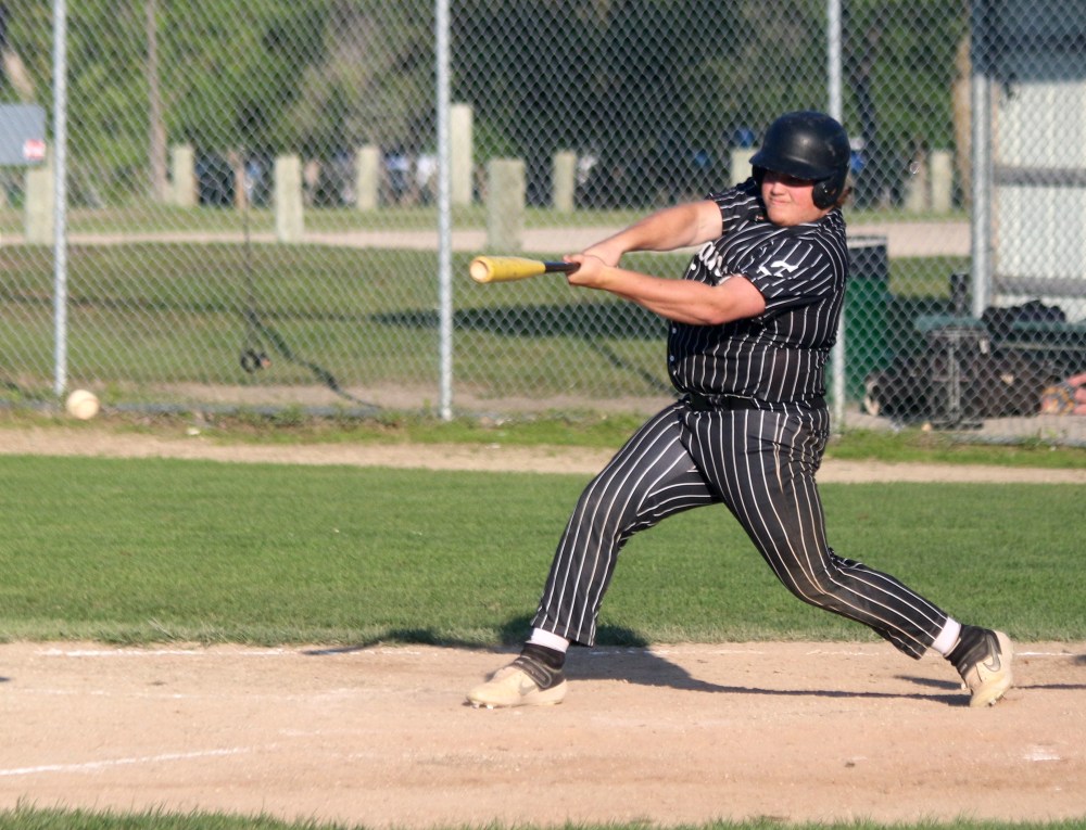 Cooper Penner knocks a ball in play during the Sultans 11-6 win over Winnipeg South July 5 at A.D. Penner Park. (Cassidy Dankochik The Carillon)