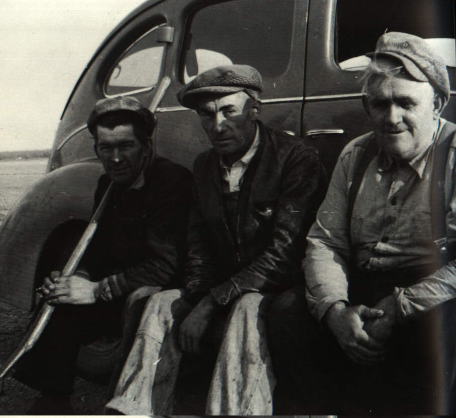 Left, John Bergen, Cornelius Falk, and Jakob Dueck taking a break from fighting the Rosengard bush fire, Fall, 1948.