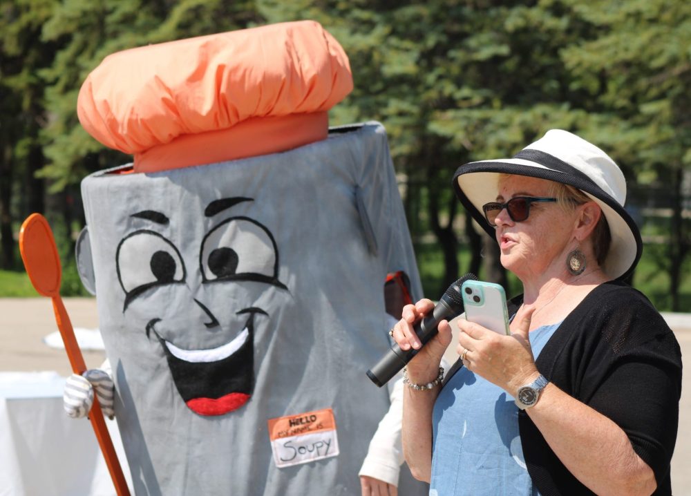GREG VANDERMEULEN THE CARILLON
As Soup’s On celebrated their 20th anniversary on July 6, founder Joy Neufeld announced she would be stepping down. She spoke to the crowd next to the organization’s new mascot, Soupy.