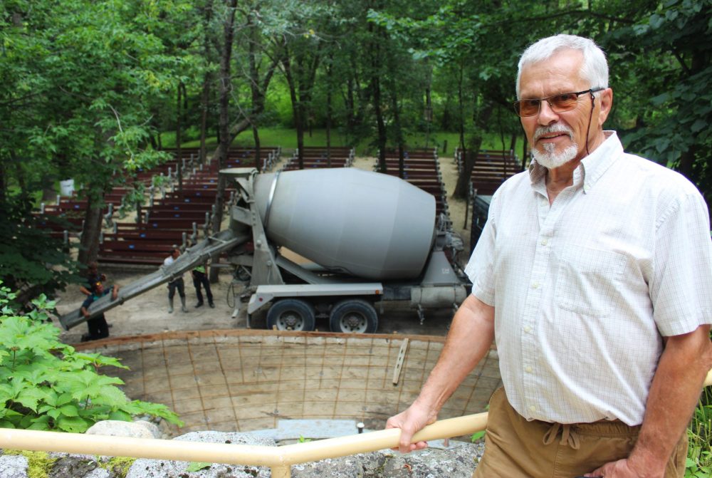 CHRIS GAREAU THE CARILLON
St Malo Parish board member Leo Roch at the Grotto as cement is poured to make the worship site along the river safer. The Grotto is one of four Parish sites that received municipal heritage site status.