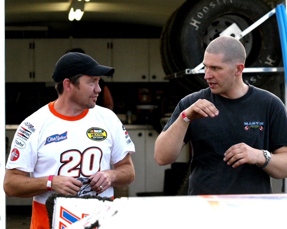 Kevin Penner and Mike Martin duke it out on the track in the Super Stock category, and after the race compare notes in the pit area of Red River Co-Op Speedway. (Alvin Derksen Carillon Archives)