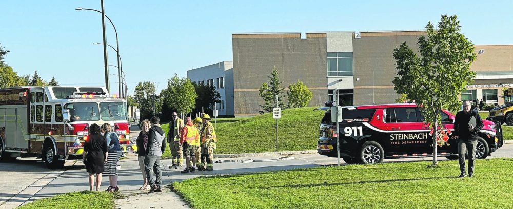 CARILLON ARCHIVES
Steinbach firefighters, high school staff and Hanover School Division administration at the end of the Steinbach Regional Secondary School bus loop where a Hanover school bus struck a six-year-old girl on Sept. 11, 2023. The school division has concerns about traffic and pedestrian safety at the school’s intersection. The city says there is no reason to be concerned as other than that one incident with the six-year-old there were no other pedestrian incidents at the school going back 14 years.