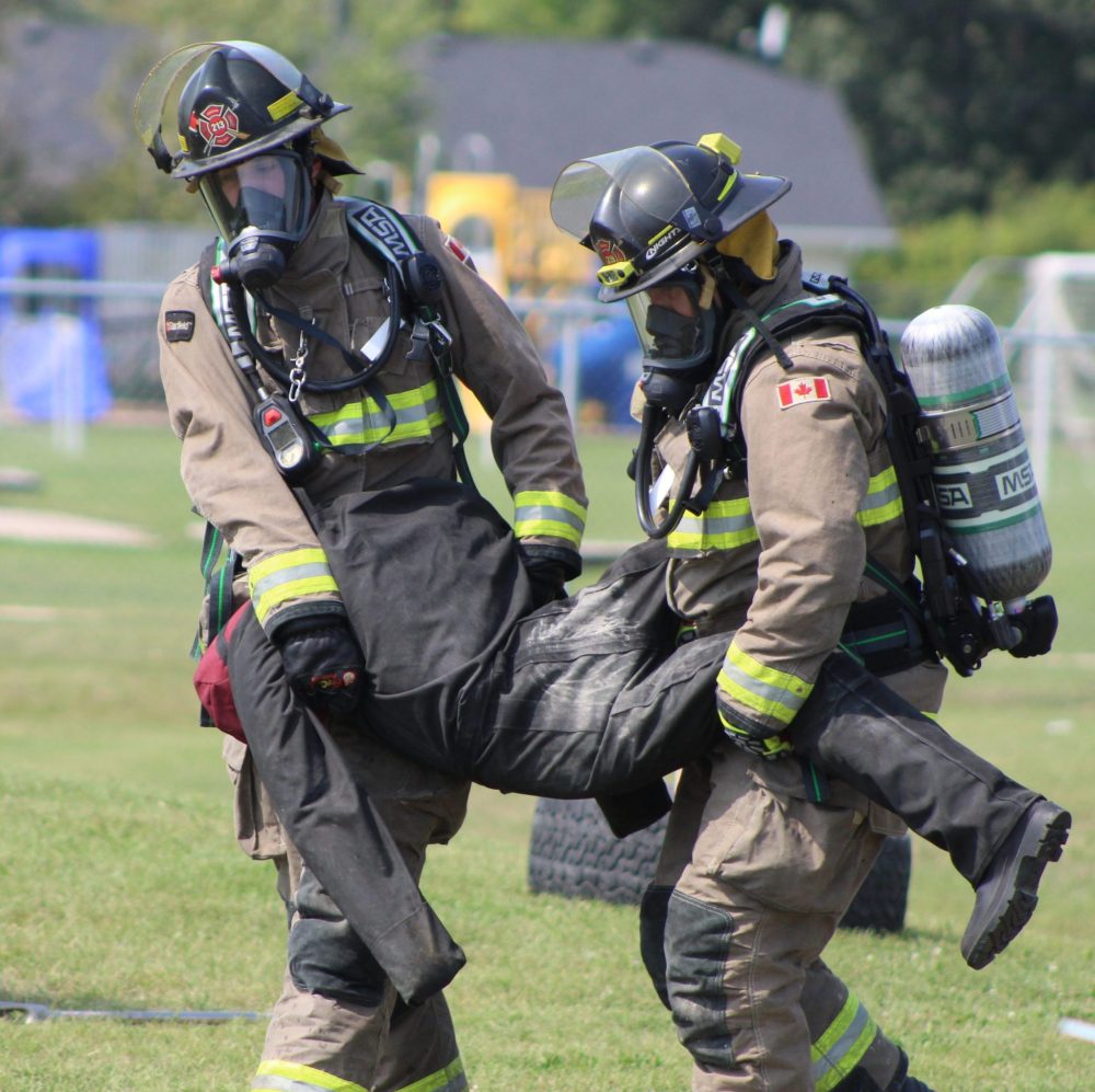 CHRIS GAREAU THE CARILLON
Hanover Fire Rescue's Kleefeld station two members save the dummy at the Cornerstone Firefighter Challenge at Kleefeld Honey Festival. Hanover won the challenge in very challenging hot and humid conditions. Richer and Reynolds firefighters also faced the gauntlet in full gear.