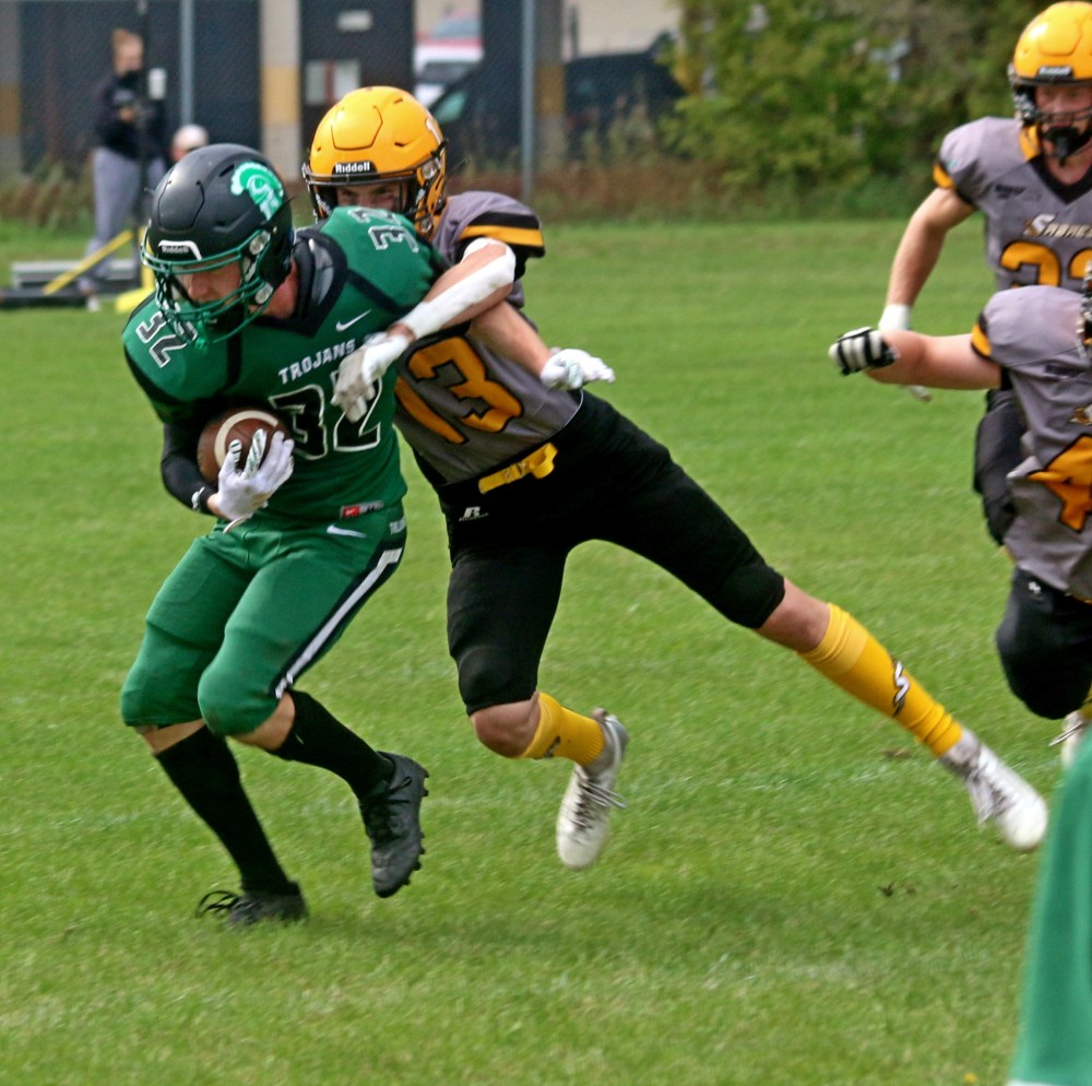 Steinbach's Juddah Wohlgemuth tackles the Vincent Massey punter after the Sabres' rushers forced the would be kicker to stop his punt attempt to try and run for a first down. (Cassidy Dankochik The Carillon)