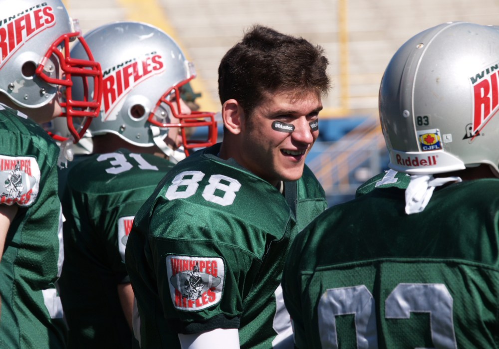 Jamie Peters (88) confers with his Winnipeg Rifles teammates at the Winnipeg Stadium as the team defeats Regina 38-23 to qualify for the 2004 Prairie Football Conference playoffs. (Terry Frey Carillon Archives)