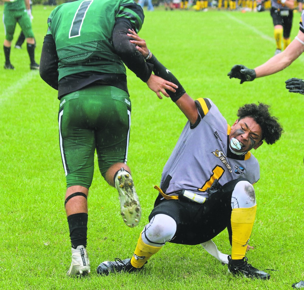 Braeden Sinclair and his Vincent Massey counterpart were given offsetting roughing penalties after Sinclair's helmet was knocked off during the final play of the first half. (Cassidy Dankochik The Carillon)