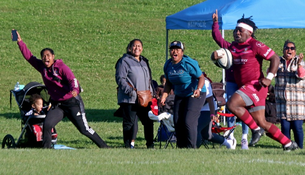 Simeli Naivalu got an escort from Eastman Warriors fans as he runs for a first-half try during Eastman's 43-24 premier division championship victory Sept. 21. (Cassidy Dankochik The Carillon)