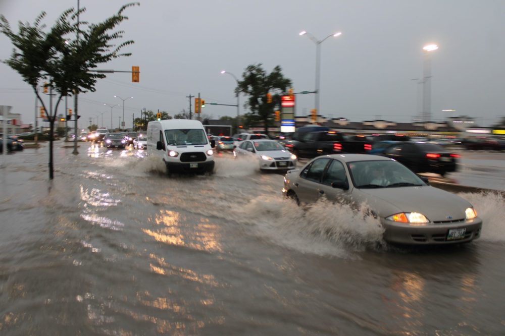 GREG VANDERMEULEN THE CARILLON
Water filled Main Street east of Brandt on Tuesday afternoon as motorists made their way home.