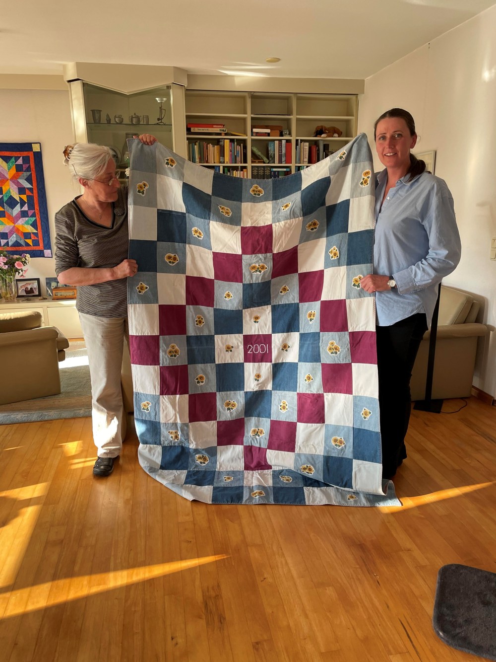SUPPLIED
Melanie Giesbrecht (right) with her host mom in the Netherlands, Marijke Laane, holding on of Stoesz's blankets, inspired by Van Gogh's Sunflowers.
