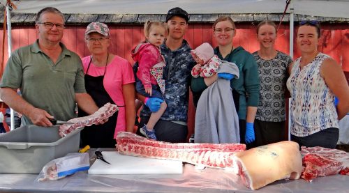 WES KEATING THE CARILLON 

Every member of the Froese family has a job during the cutting up of a 200-pound pork carcass at the museum. They are: Bill, Sheila, Mark and Katherine (holding Kianna and Josie), Rachel, and Joanne.