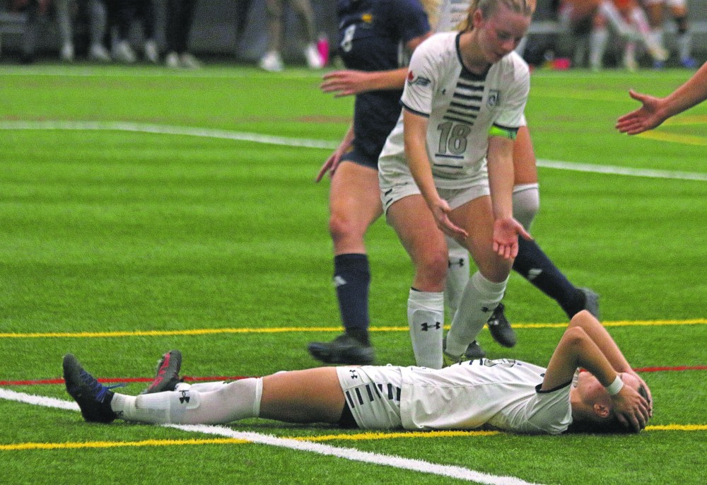 Ava Temple could do nothing but hold her head in her hands after missing a glorious chance to tie the Manitoba Colleges Athletic Conference provincial final for Providence College. (Cassidy Dankochik The Carillon)