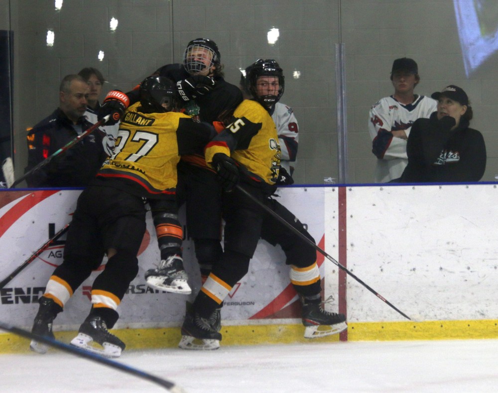 A East St Paul Gators player is sandwiched in the corner by a pair of Macdonald Swarm players while Mitchell Mustangs players look on. (Cassidy Dankochik The Carillon)
