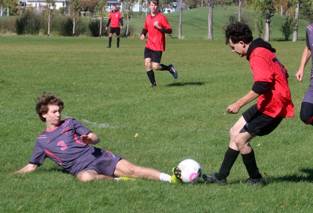 A Niverville player shows great form during a slide tackle in the Zone 13 soccer finals. The Panthers defeated Gabrielle-Roy 1-0, earning a spot at the provincial championships. (Cassidy Dankochik The Carillon)