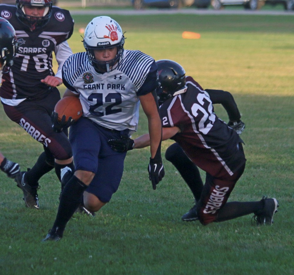 A Grant Park running back dekes around a Springfield defender en route to a second-half touchdown. (Cassidy Dankochik The Carillon)