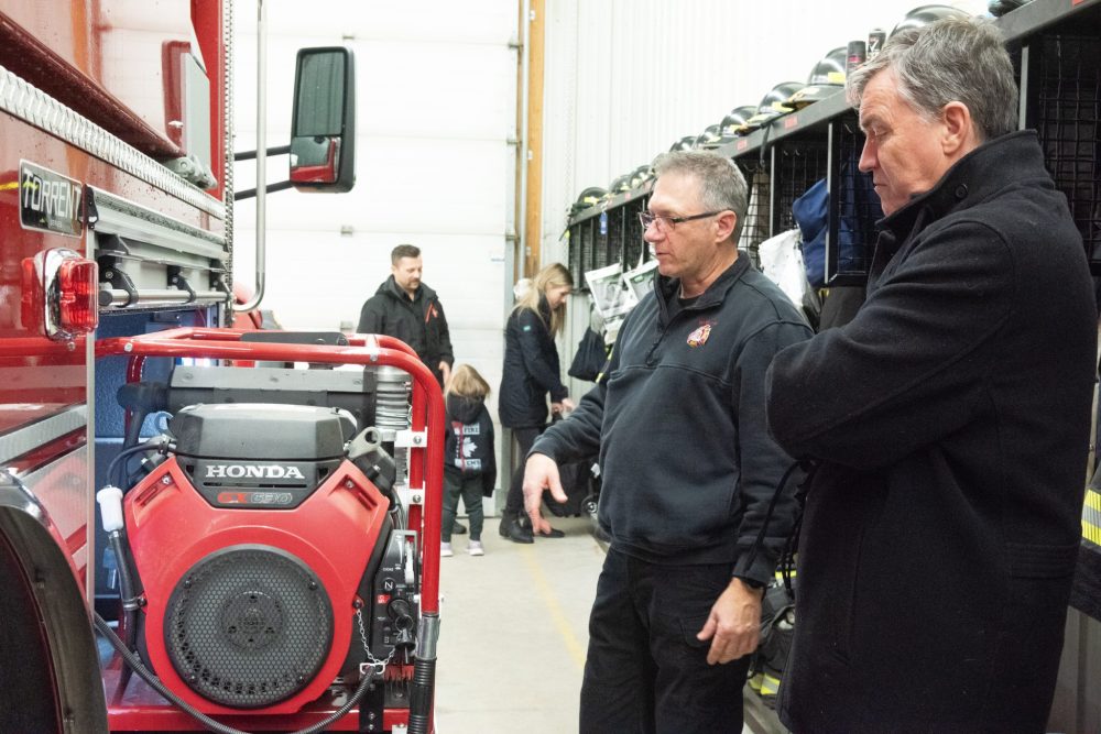 SVJETLANA MLINAREVIC THE CARILLON
Niverville deputy chief Brad Wasilinchuk shows Mayor Myron Dyck the pump for the department's new water tanker on Nov. 26, 2024. The tanker can hold 9,464 litres of water and has two side drop down tanks that can hold 11,355 litres each of water. This model replaces the department's 1993 tanker.