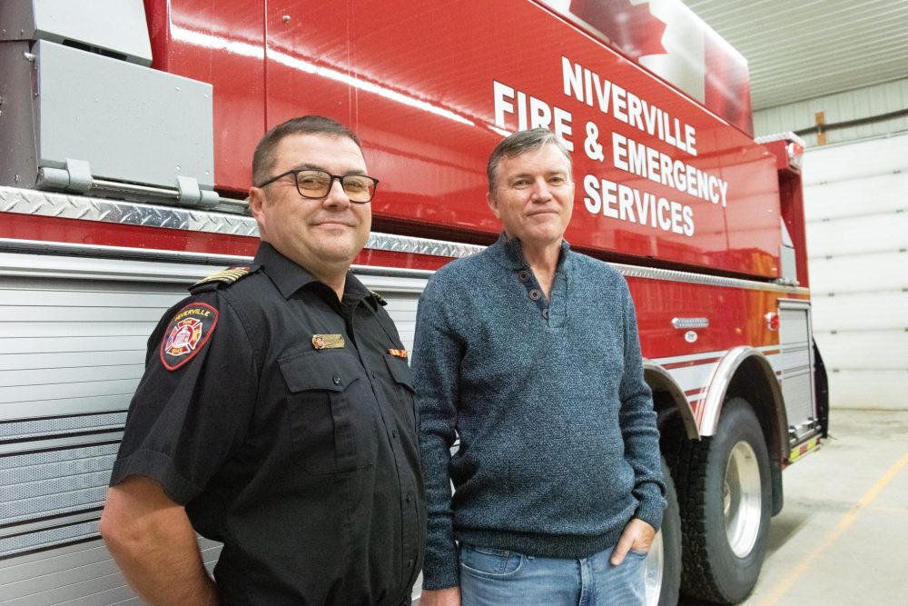 SVJETLANA MLINAREVIC THE CARILLON
Niverville fire chief Keith Bueckert stands in front of the department's new water tanker with Mayor Myron Dyck on Nov. 26, 2024. The tanker can hold 9,464 litres of water and has two side drop down tanks that can hold 11,355 litres each of water. This model replaces the department's 1993 tanker.