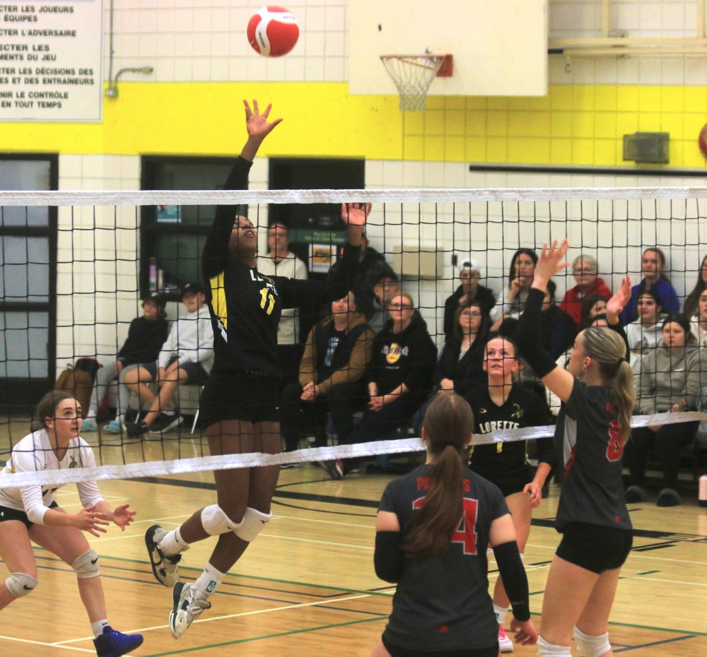 Lorette's Kiana McDonald pushes the ball over the net during the 2024 Zone 13 AAA girls varsity volleyball championships. (Cassidy Dankochik The Carillon)
