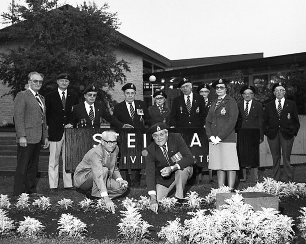 CARILLON ARCHIVES
Steinbach Councillor George Neufeld and Fred Cross, president of the Steinbach branch of the Royal Canadian Legion, plant bulbs from Holland in front of the Steinbach Civic Centre in a brief ceremony. Looking on in the background are Legion and Auxiliary members Walter and Tina Barkman, Ove Larsen, Henry Reimer, Tien Barkman, Neil Friesen, Peter Kehler, Fred Barkman and Martha Wiebe.