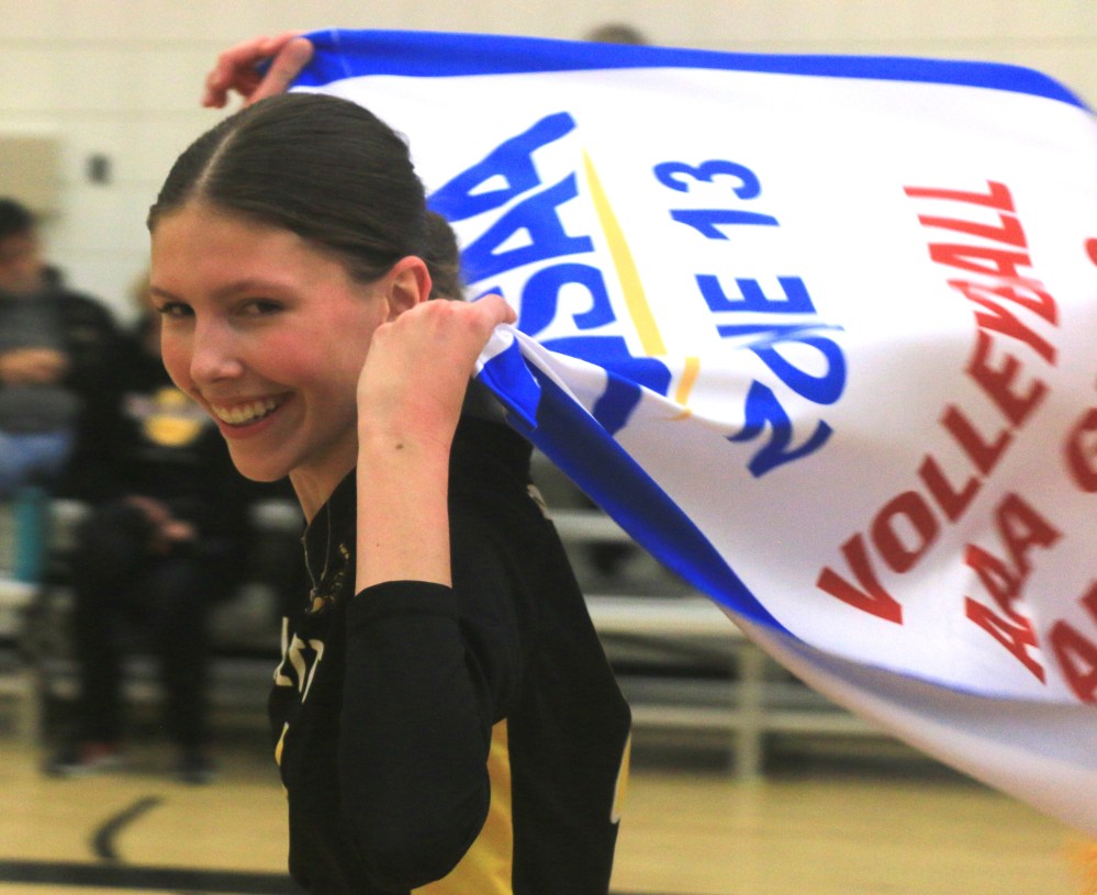 Lorette's Kaylee Visser took the Zone 13 AAA banner for a lap around her home gym after the Scorpions took out the Niverville Panthers to win the championship. (Cassidy Dankochik The Carillon)