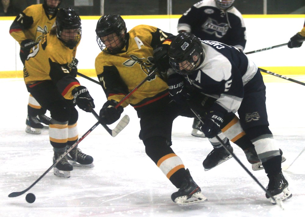 Mattix Carpenter lays a strong hit on a Macdonald Swarm player during his team's 5-0 win Nov. 16. The Springfield Xtreme are 11-0 on the season in the HTJHL. (Cassidy Dankochik The Carillon)