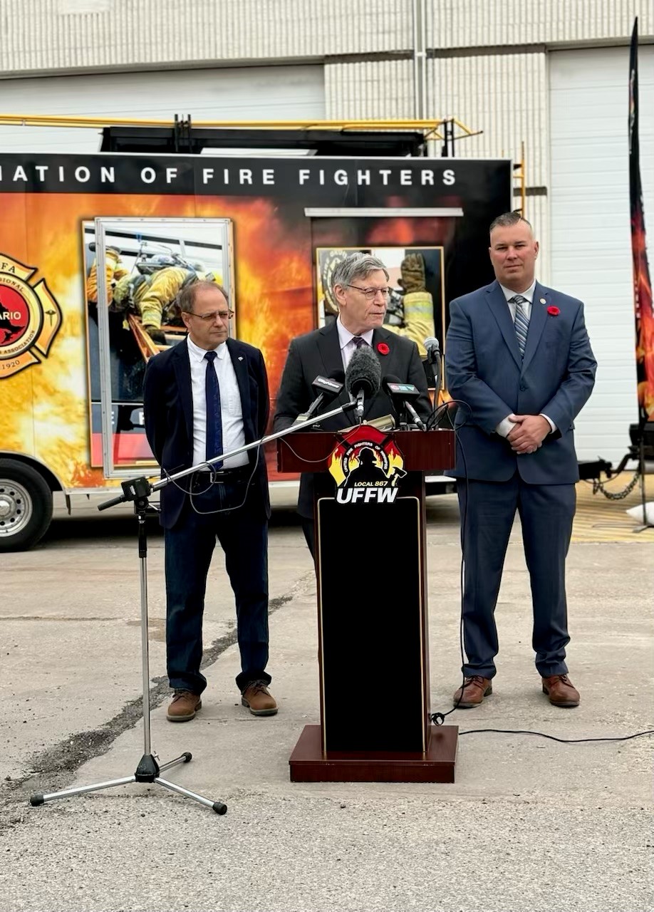 Submitted
Winnipeg South MP Terry Duguid talks at the podium during the announcement of the investment of $12 million into cancer awareness and prevention for firefighters on Nov. 1 at the Winnipeg Fire Paramedic Training Academy, Stores, and Mechanical Services. He is flanked by Winnipeg North MP Kevin Lamoureux and United Firefighters of Winnipeg President Tom Bilous.