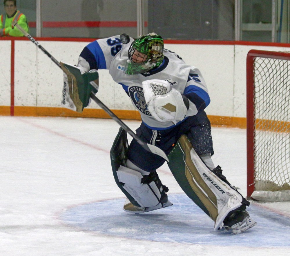 Christian Green fights off a shot during a game against Northern Manitoba earlier this season. The 2004-born goalie from Pennsylvania was named the Original 16 goaltender of the month for the Manitoba Junior Hockey League in November. (Cassidy Dankochik The Carillon)