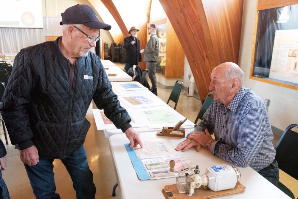 SVJETLANA MLINAREVIC THE CARILLON
Abe Friesen (left) looks at ration cards from the Second World War brought by Al Hamm to display at the Mennonite Heritage Village's hosting of the Manitoba Historical Society’s EastMenn historical committee, which studies the Mennonite east reserve, annual general meeting on Jan. 25, 2025.