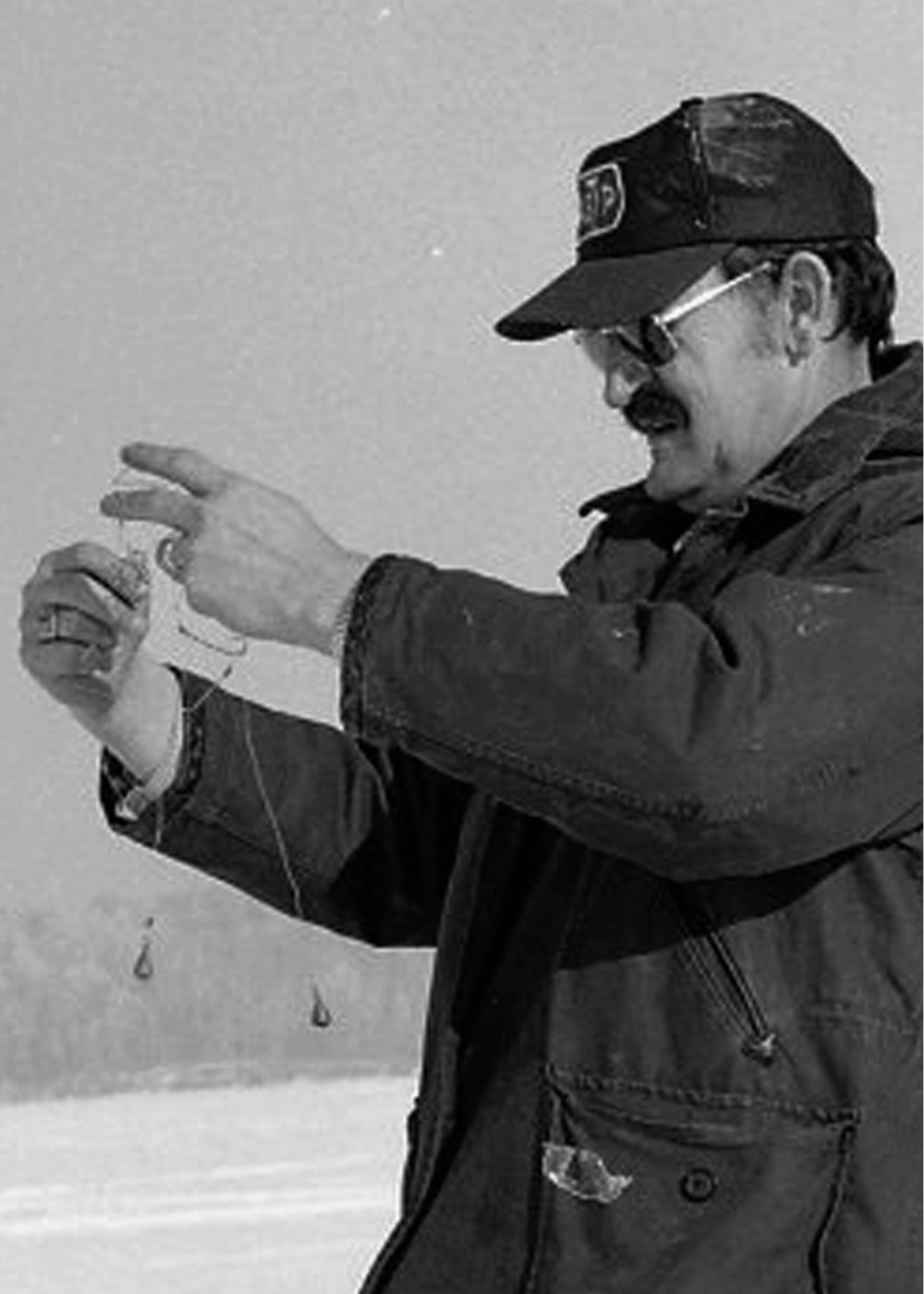 Jim Lohr thought if he could just pull that sinker through there and unwind that piece of line and get that leader away from that other sinker and that hook from between the two weights he would be all ready to put bait on this one. (Carillon Archives)