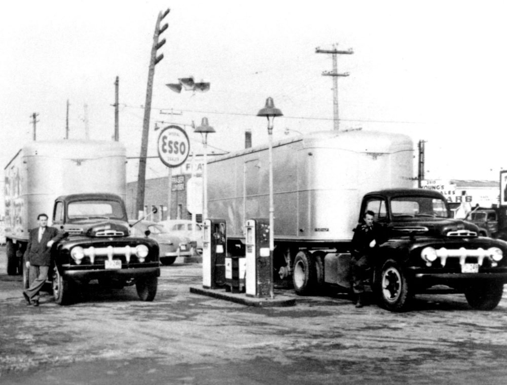 CARILLON ARCHIVES
In this January, 1952 photo, P.K. Penner, at left, and Levi Barkman refuel Penner’s Transfer’s first two tractor-trailer units at the Bill Sweet Service Station in Windsor, Ontario before setting out for Winnipeg with their very first loads of Ford parts.