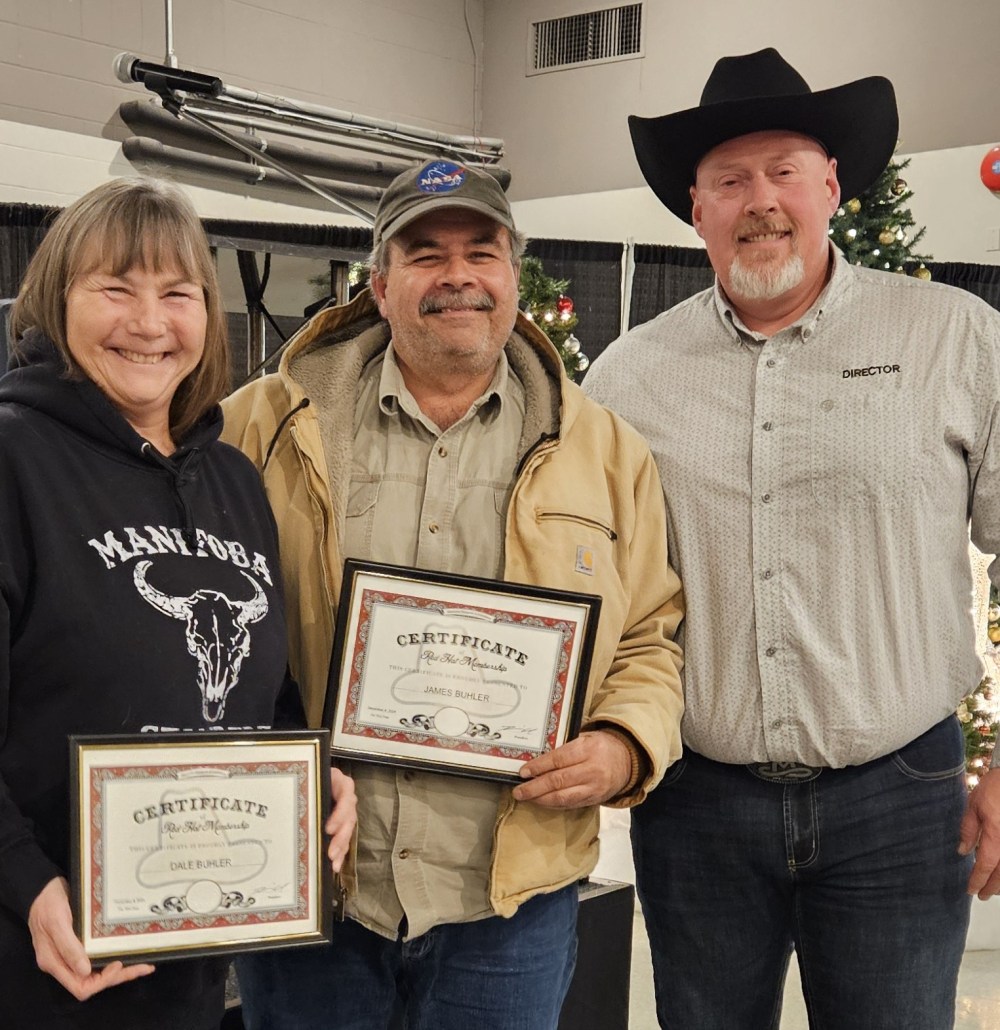 SUPPLIED
Red Hat Award recipients James and Dale Buhler accept their awards from past president Brian Wiebe.