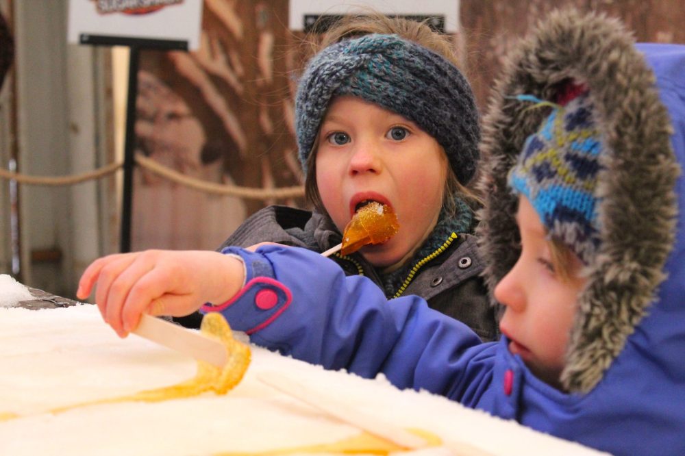 Niverville sisters Jenny, 6, and Millie Legal, 4, roll up their maple taffy on the snow at Festival du Voyageur’s Cabane à Sucre Feb. 15. The tradition is run by Musée St-Pierre-Jolys. The museum’s next event is the Sugaring Off Festival April 3-6 in St Pierre, which will have maple syrup production, historical re-enactments, live music, children’s activities and more.