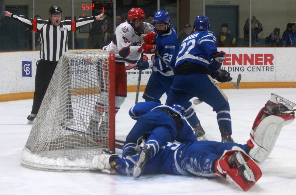 Referees kept a close eye to make sure the puck didn't cross the goal line during this key third period play wioth the game tied during game one of the Steinabach Huskies series against Mitchell in the HTJHL playoffs. The Huskies would go on to nab a late game one winner, en route to a series sweep. (Cassidy Dankochik The Carillon)