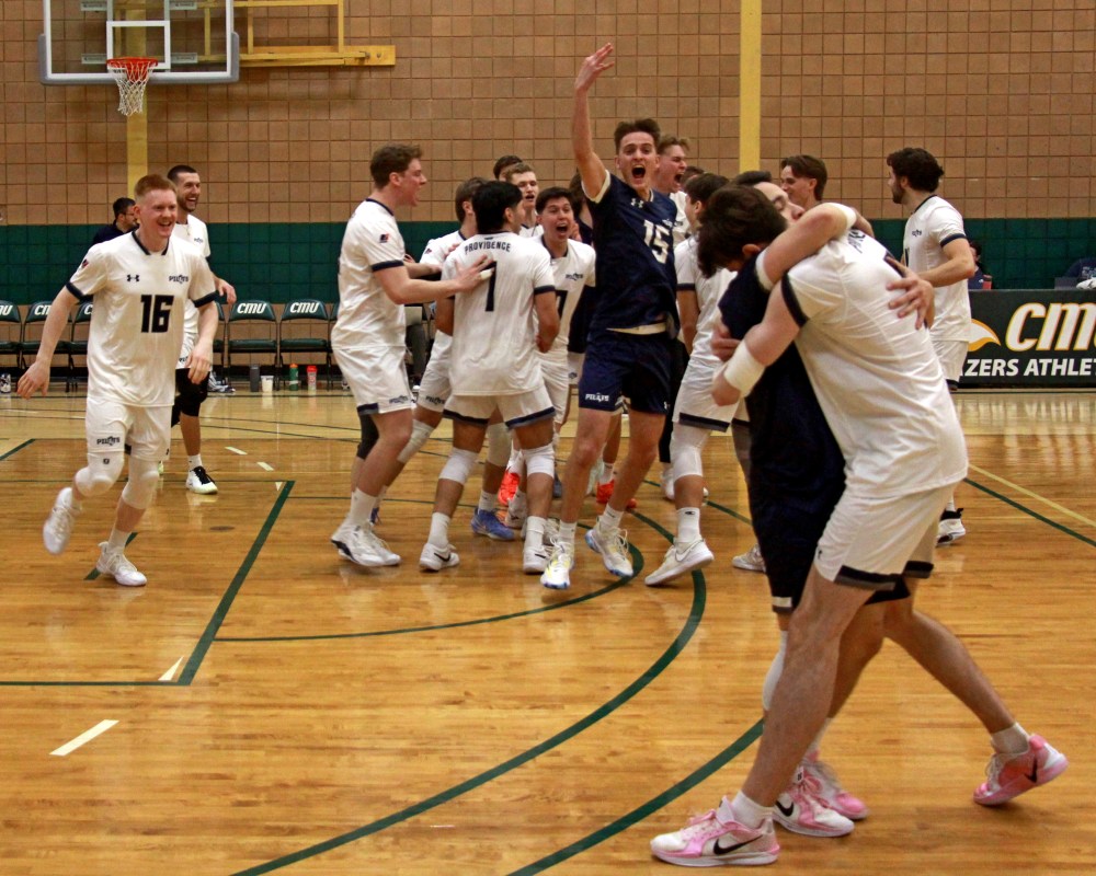 The Providence bench empties onto the court after the final point of the MCAC finals at Loewen Gym on the CMU campus Feb. 22. (Cassidy Dankochik The Carillon)