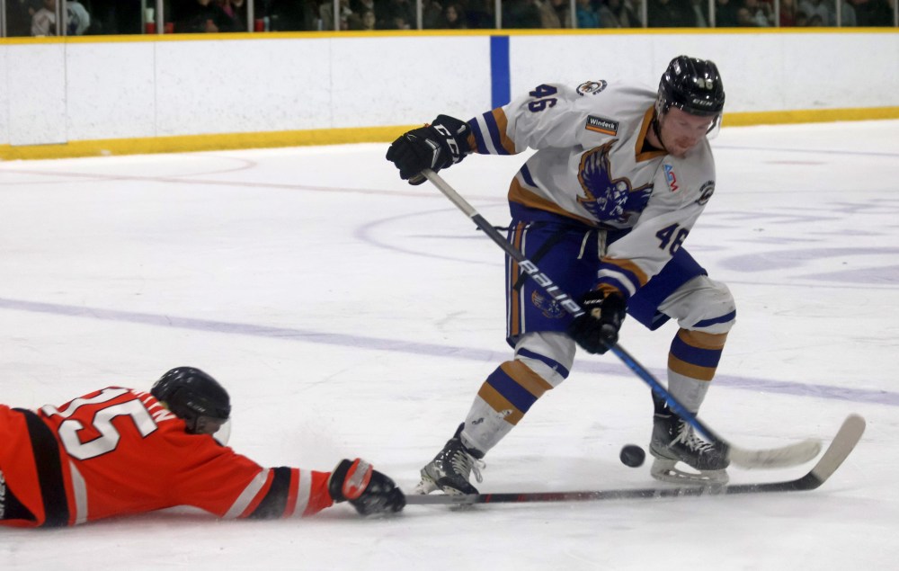 Stephane Pattyn dives to clear the puck from his own zone during game six of the SEMHL finals March 21. (Cassidy Dankochik The Carillon)