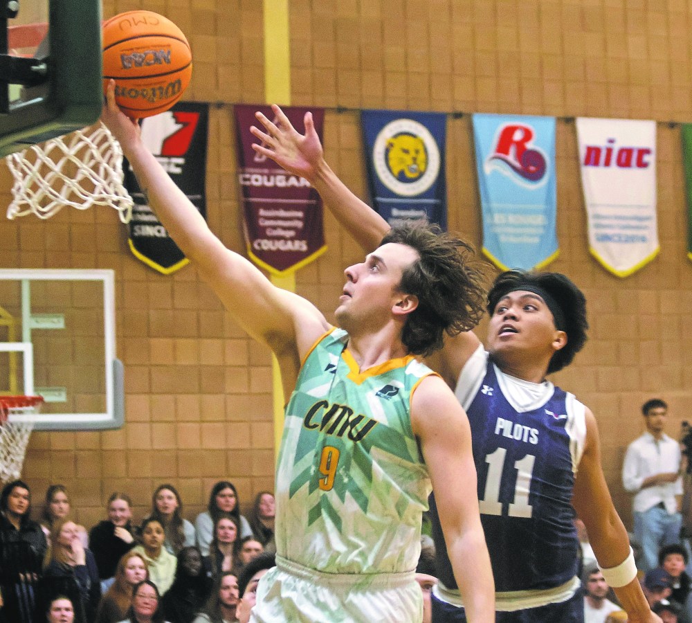 CMU's George Fedorchuk lays a ball into the net during the second half of their blowout championship victory over the Providence Pilots Feb. 28. (Cassidy Dankochik The Carillon)
