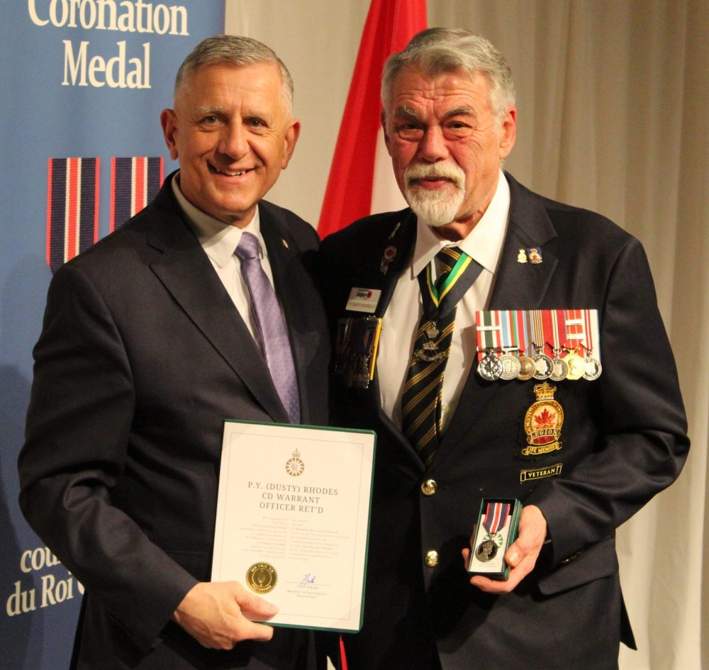 CHRIS GAREAU THE CARILLON
Paul ‘Dusty’ Rhodes (right) from Niverville receives his Medal from Provencher MP Ted Falk after 33 years with the Canadian Armed Forces, and service at home as a coach and camp director among other things.