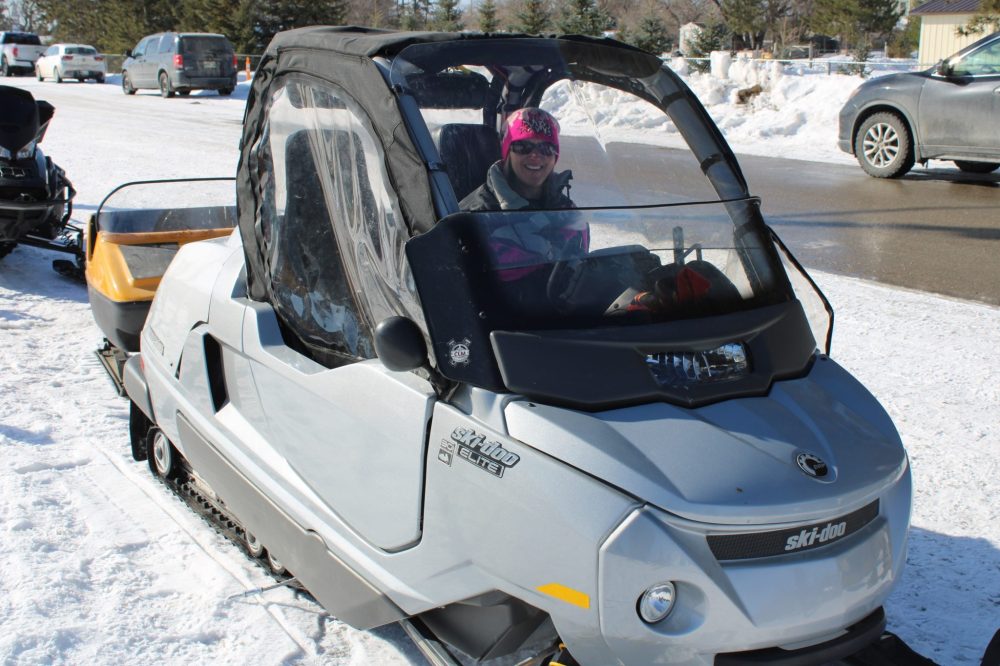 GREG VANDERMEULEN THE CARILLON 

Bonnie Mandziuk poses in Darryl Paterson’s unique albeit modern model, a limited edition Ski-Doo built in Quebec and powered by a 1.5 litre Sea-Doo motor. The comfortable sled seats two side by side and includes a stereo and heater.
