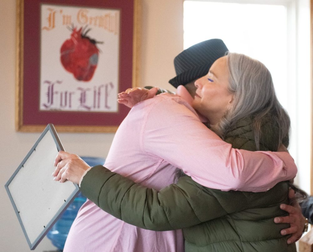 SVJETLANA MLINAREVIC THE CARILLON
Minister of Families Nahanni Fontaine visited the El'dad Ranch in Steinbach on Tuesday April 1, 2025, to see firsthand the work that the agency is doing. Here El'dad resident Michael Meeko McDonald gives her a hug after giving her a painting he made depicting his life on the streets and involvement with drugs and how he has become rehabilitated. El'dad helps residents with intellectual disabilities who are part of the alternative justice program and those who are in the day program learn life skills and get employment.