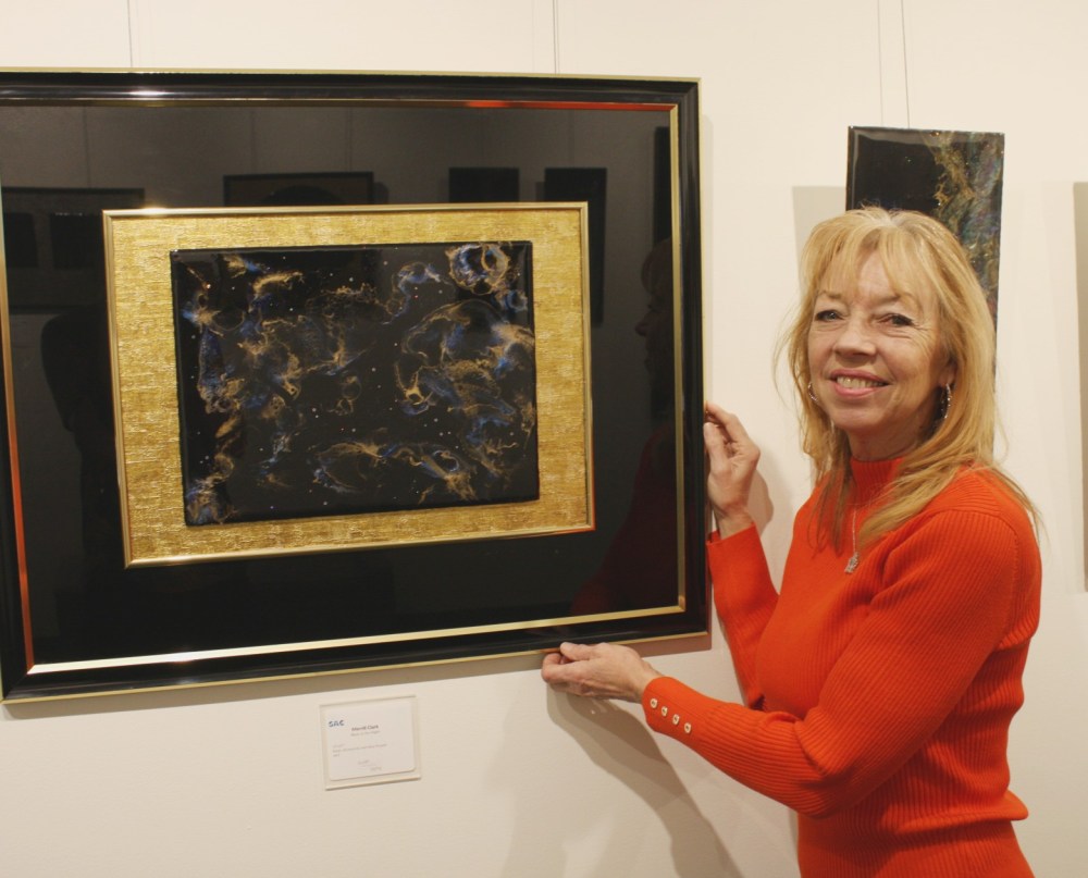 Submitted
Merrill Clark stands next to one of her pieces at the Steinbach Arts Council’s Hall Gallery.