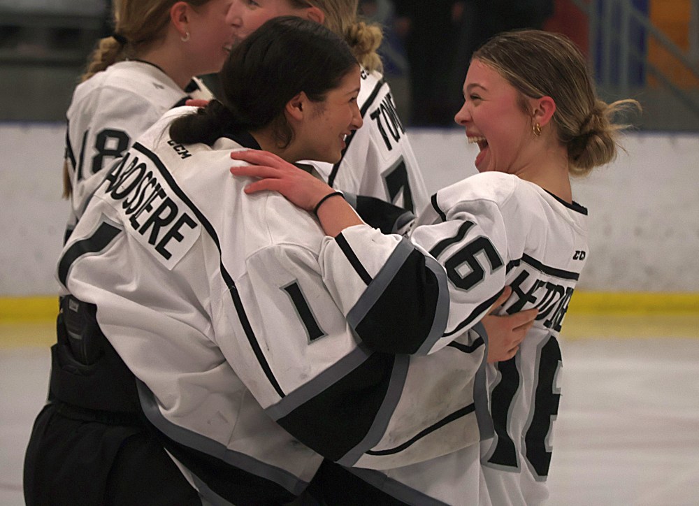 Sophia Heidinger, who scored the series-winning goal in double overtime, celebrates with goaltender Isabelle Labossiere after the game. (Cassidy Dankochik The Carillon)