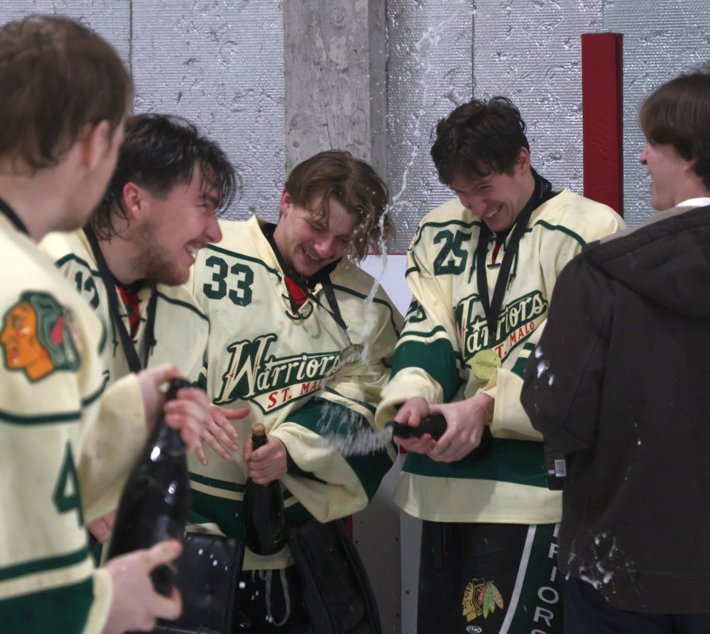 The St Malo Warriors popped bottles of Champagne in celebration of back-to-back CRJHL championship victories. (Cassidy Dankochik The Carillon)