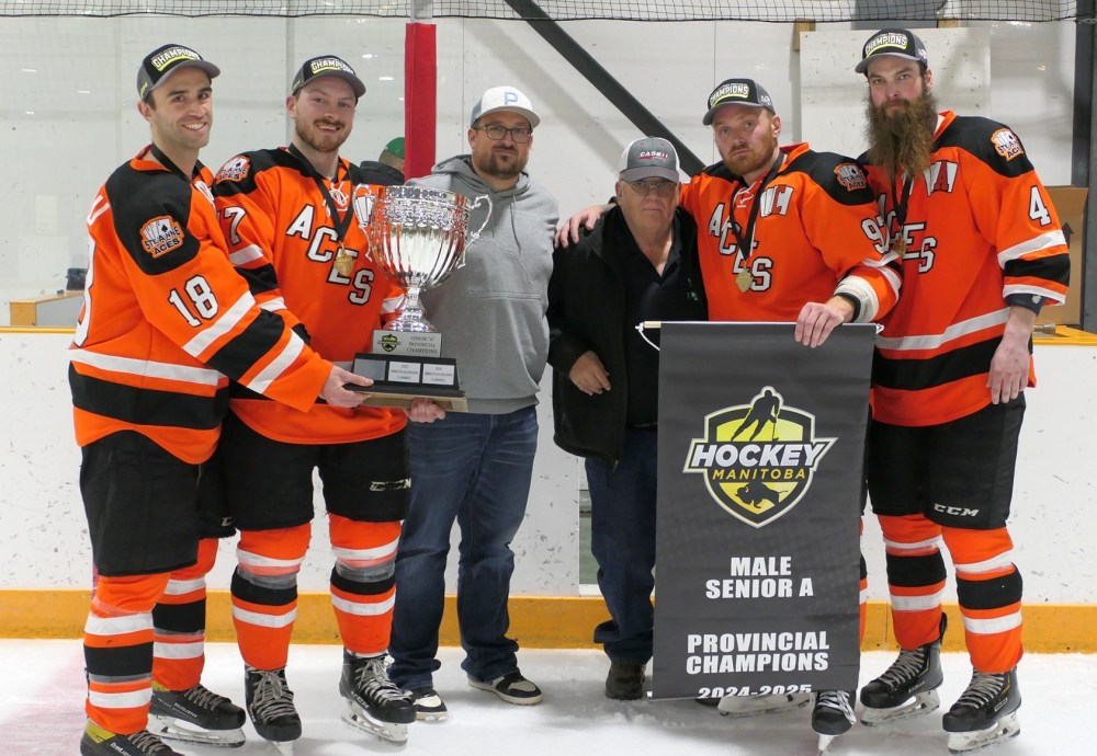 The Aces leadership group accepts the trophy and banner after winning the senior provincial A championship 2-0 over Killarney. (Shannon Normandeau Ste Anne Aces Facebook)