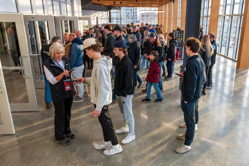 Photo by Dan Noordman
Volunteers scan tickets during a Pistons game at the Southeast Events Centre. The centre is looking for volunteers to help usher, scan tickets, be the parking crew, and greet people. Shifts vary from three to six hours depending on the event.