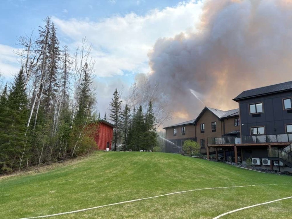 SUBMITTED BY SOUTHLAND CHURCH
Fire and smoke came dangerously close to Southland Church's Bird River Bible Camp. Here the church's Bear Lodge can be seen in the foreground of the blaze.