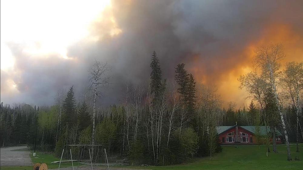 SUBMITTED BY SOUTHLAND CHURCH
Fire and smoke came dangerously close to Southland Church's Bird River Bible Camp. Here the church's Beaver Lodge can be seen in the foreground of the blaze.