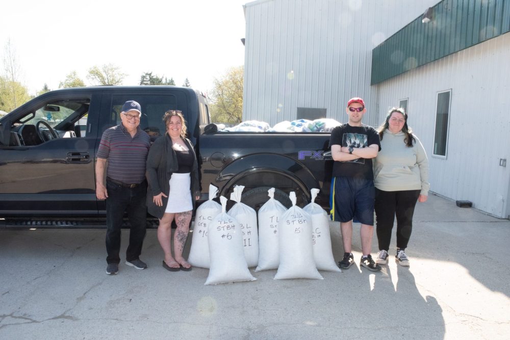 SVJETLANA MLINAREVIC THE CARILLON
Bob Barrow, who has collected millions of soda tabs over the years, stands next to Trailblazers' day program coordinator Celine Harris, Day program client Jeramee Jurkiw and trailblazers employee Annastasia Nesom. They filled the back of a truck with soda cans and had six 40-lb bags of tabs as part of a larger haul that was going to Zhoda to sell as scrap fro Tabs for Wheelchairs. Quality Metal Recovery gives top dollar (90-cents) per pound of aluminum to Tabs for Wheelchairs. Barrow collects about 350 bags of tabs per year from all over the southeast which he uses to fund new wheelchairs for children under 18 years old.