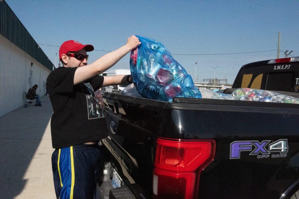 SVJETLANA MLINAREVIC THE CARILLON
Trailblazers' day program client Jeramee Jurkiw throws a bag of cans into the back of a truck as part of a larger haul that was going to Zhoda to sell as scrap for Tabs for Wheelchairs. Quality Metal Recovery gives top dollar (90-cents) per pound of aluminum to Tabs for Wheelchairs. The Southeast chapter of the organization collects about 350 bags of tabs per year from all over the area which is then used to fund new wheelchairs for children under 18 years old.