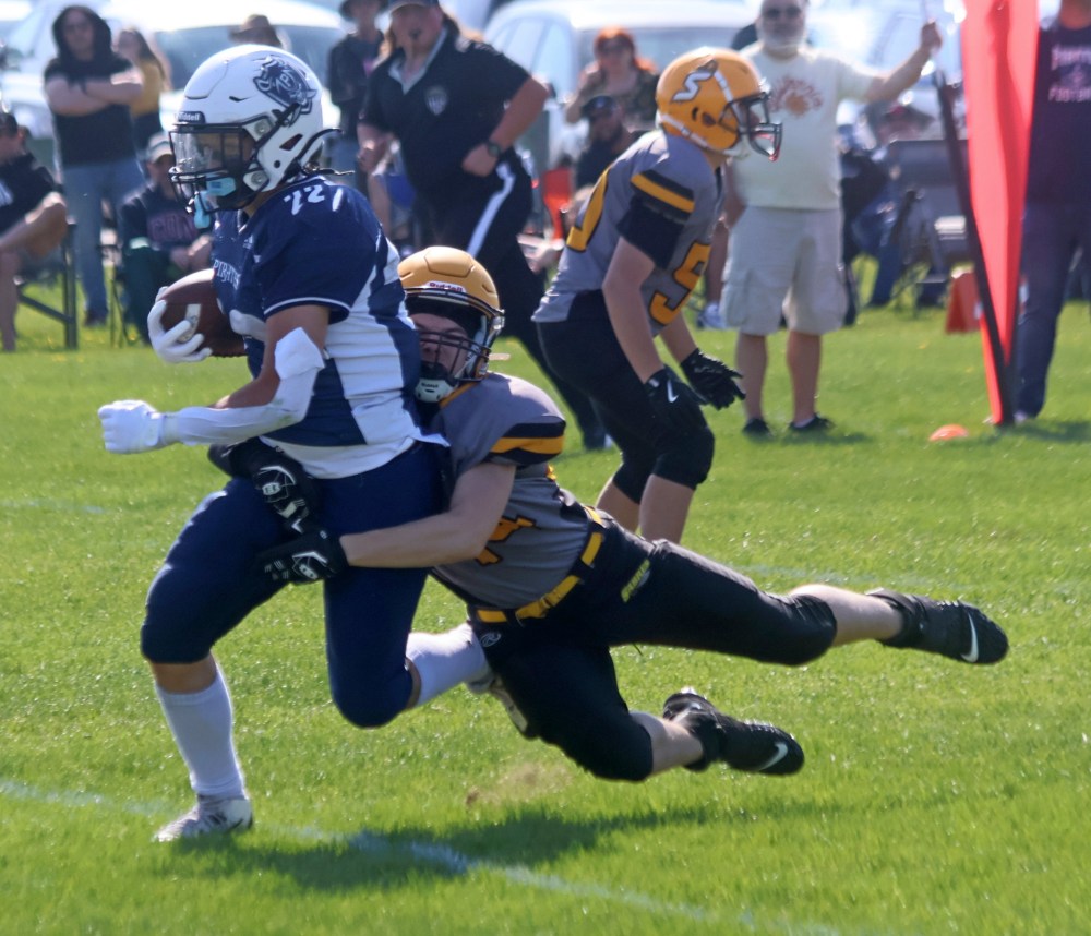 An SRSS junior varsity player tackles an opponent during the team's spring game against Grant Park. (Cassidy Dankochik The Carillon)