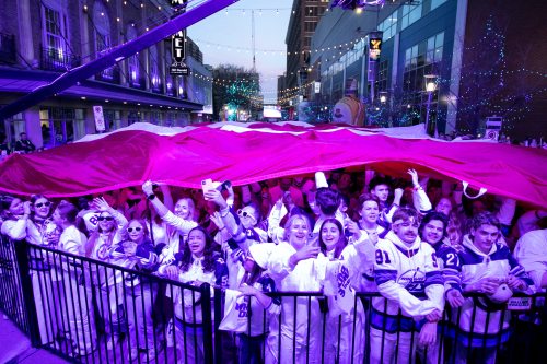 BROOK JONES/FREE PRESS
Winnipeg Jets fans cheer while holding a large Canadian flag during the singing of Canada's national anthem moments before the start of Game 5 of the National Hockey League Stanley Cup playoff between the hometown Winnipeg Jets and the visiting St. Louis Blues. The Whiteout street party took place on Donald Street in Winnipeg, Man., Wednesaday, April 30, 2025.