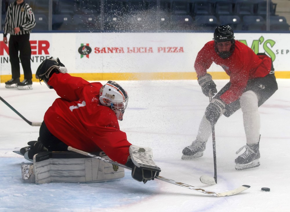 A goalie pokes a puck away during a scrimmage at the Steinbach Pistons spring camp. (Cassidy Dankochik The Carillon)